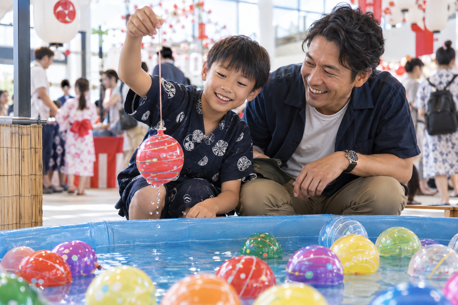 A boy enjoying Japanese water yo-yo fishing with his father